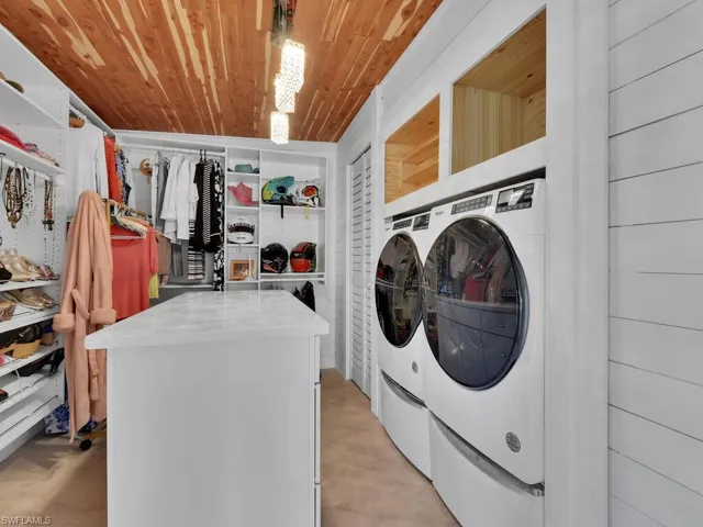 Bonus utility room with wooden ceiling, built in closet organizers and independent washer and dryer