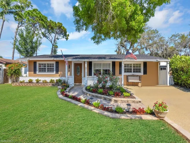 Ranch-style house with a front lawn and a porch
