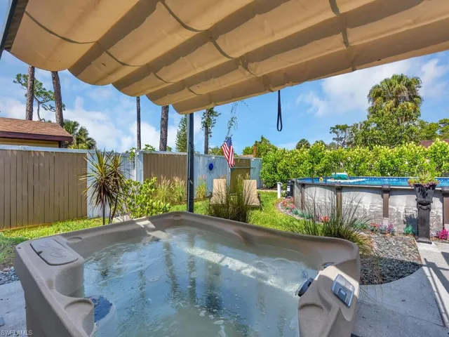 View of pool with a covered hot tub area