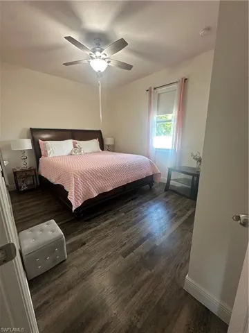 Bedroom featuring dark wood-style flooring and a ceiling fan