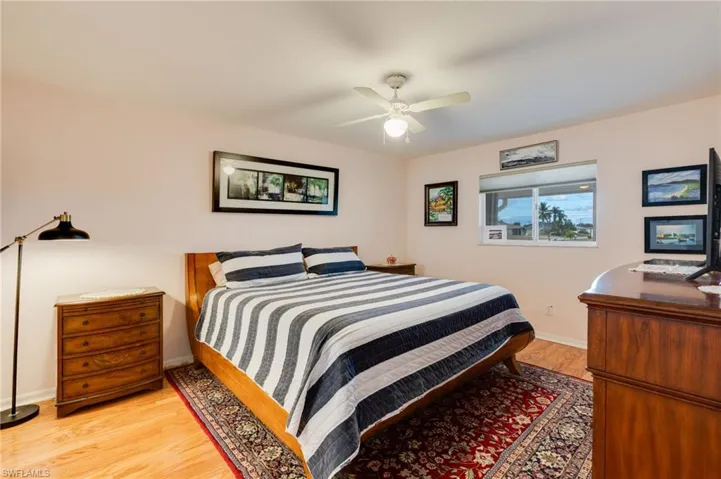 Bedroom with light wood-style floors and a ceiling fan