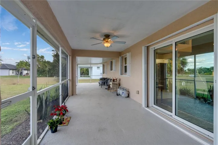 Unfurnished sunroom featuring ceiling fan