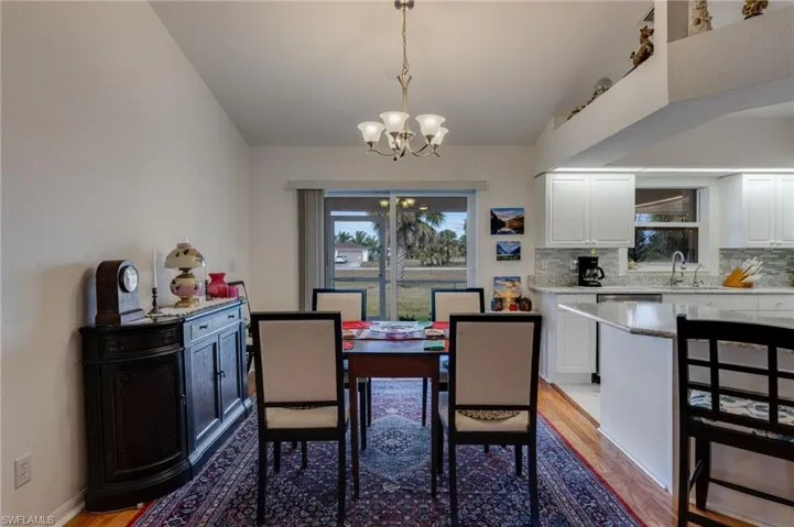 Dining area with light wood-type flooring and a chandelier