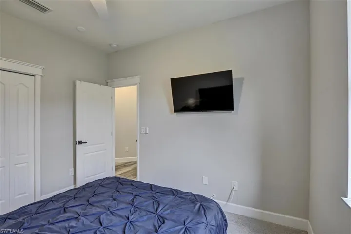 Carpeted bedroom featuring baseboards and a ceiling fan