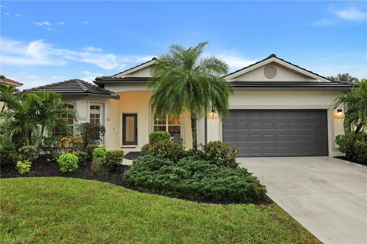 View of front of home featuring driveway, a garage, stucco siding, and a front lawn