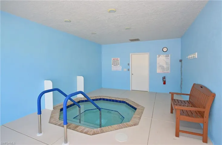 View of swimming pool featuring an indoor in ground hot tub