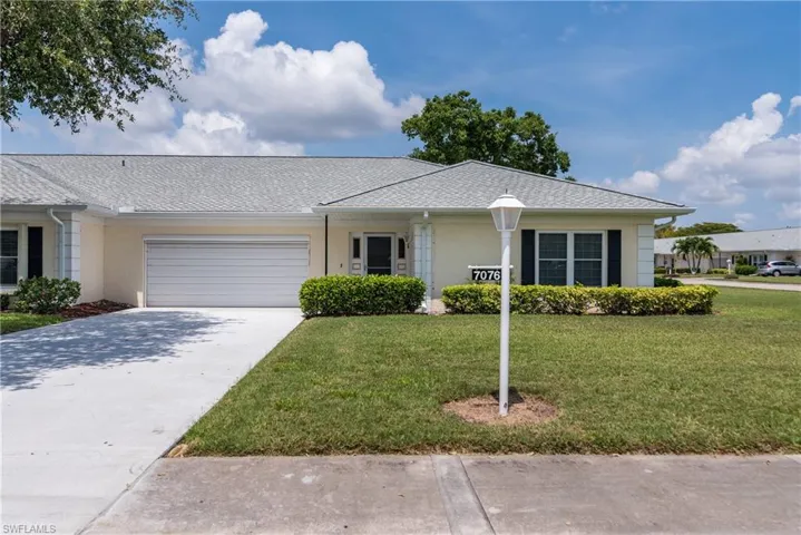 Single story home featuring an attached garage, a front yard, stucco siding, and concrete driveway