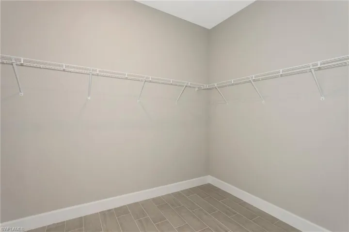 Spacious closet featuring hardwood / wood-style floors