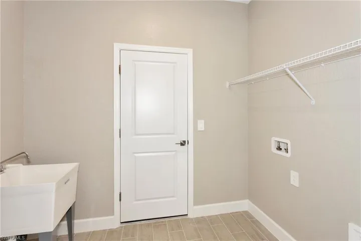 Clothes washing area with hookup for a washing machine and sink