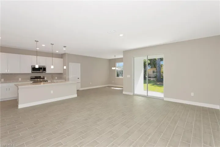 Unfurnished living room featuring sink