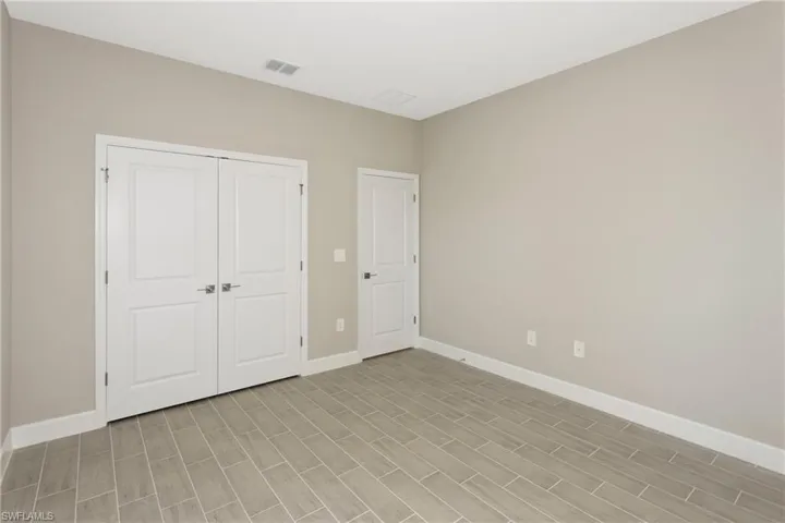 Unfurnished bedroom featuring a closet and light wood-type flooring