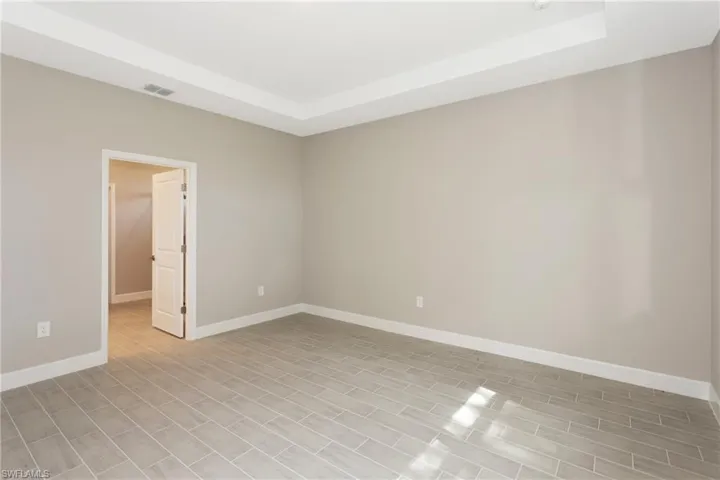 Spare room with a tray ceiling