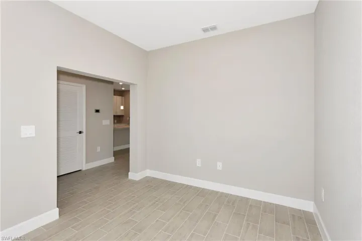 Empty room with light hardwood / wood-style flooring