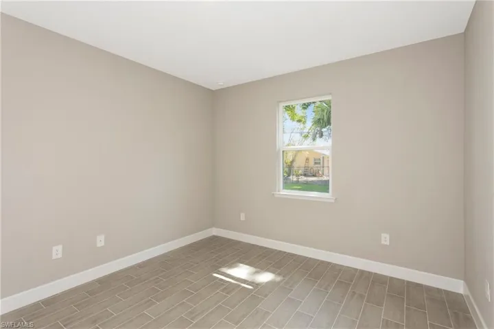 Empty room with light hardwood / wood-style floors