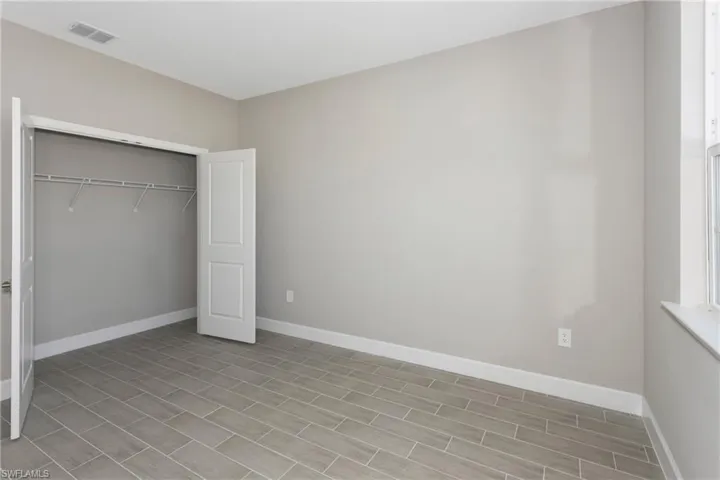 Unfurnished bedroom with a closet