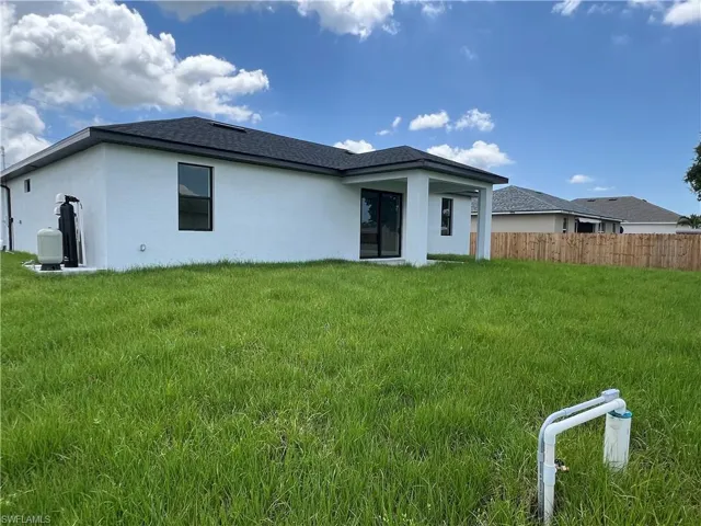 Back of house featuring a yard