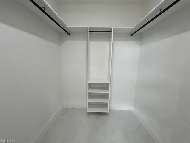 Spacious closet featuring tile patterned flooring