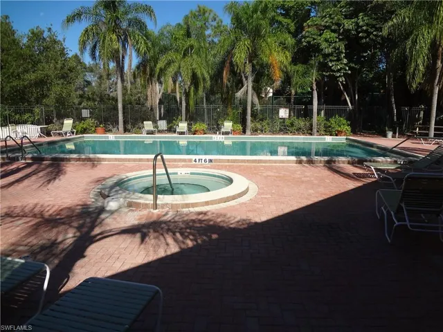 View of pool with a patio and a hot tub