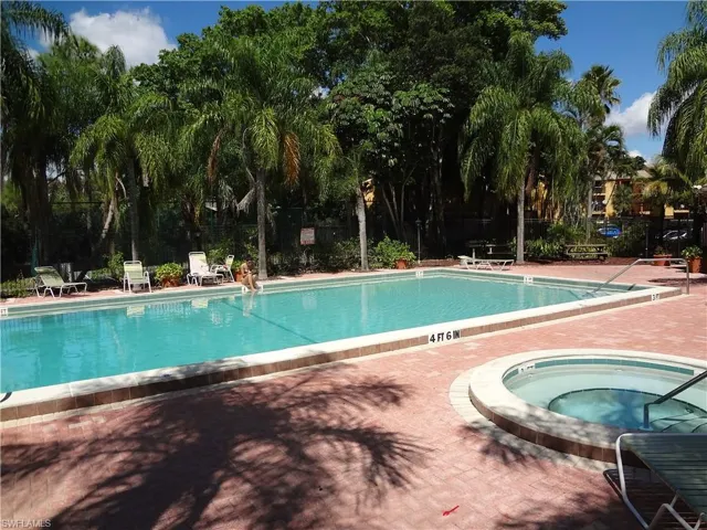 View of pool featuring a patio area and a hot tub