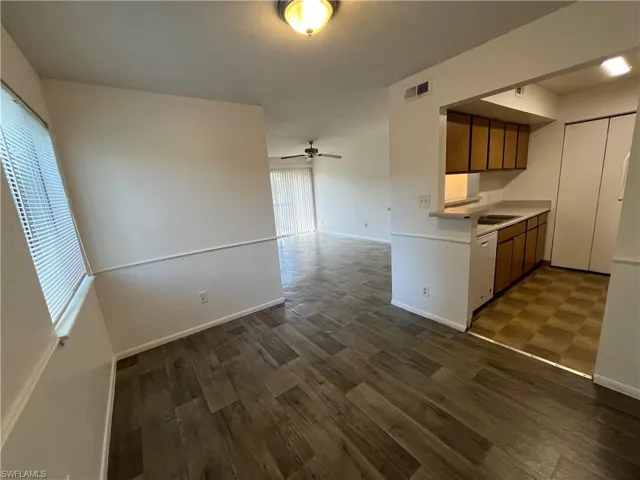 Kitchen with dishwasher, dark hardwood / wood-style flooring, ceiling fan, and sink