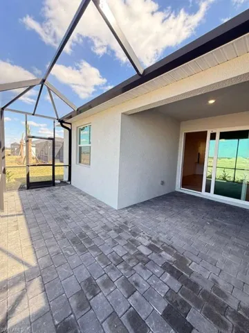 View of patio with a sunroom and glass enclosure