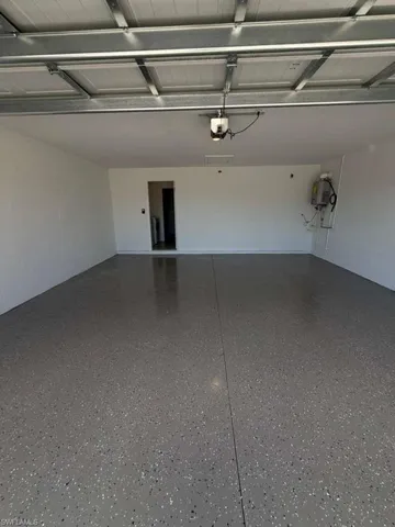 Garage featuring concrete block wall