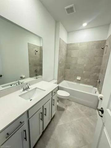 Full bathroom with  shower combination, vanity, and light tile patterned flooring