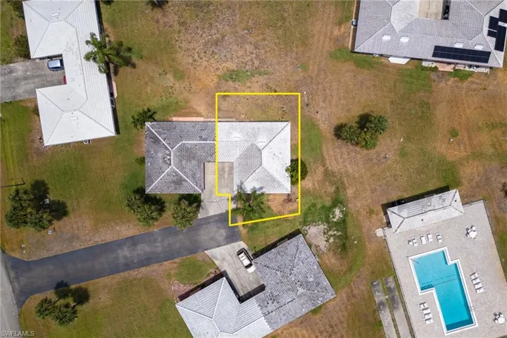 Aerial overview of property's location with property boundaries highlighted and a pool area