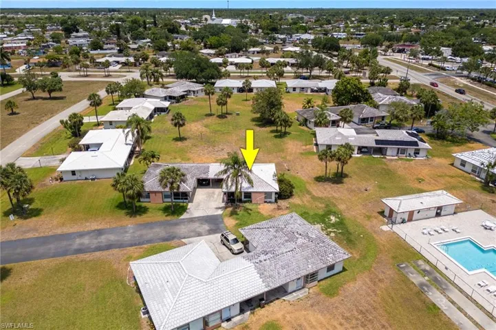 Aerial perspective of suburban area featuring a pool area
