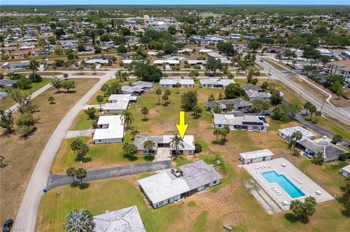 Aerial view of residential area featuring a pool area