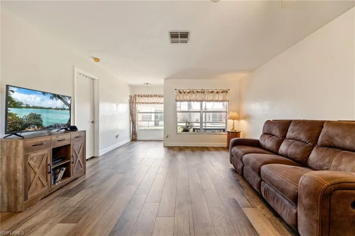 Living area with wood finished floors and baseboards