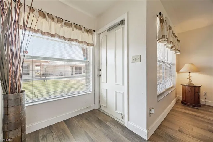 Entryway with wood finished floors and baseboards