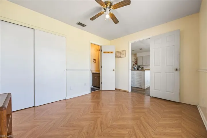 Unfurnished bedroom with a closet, baseboards, and ceiling fan