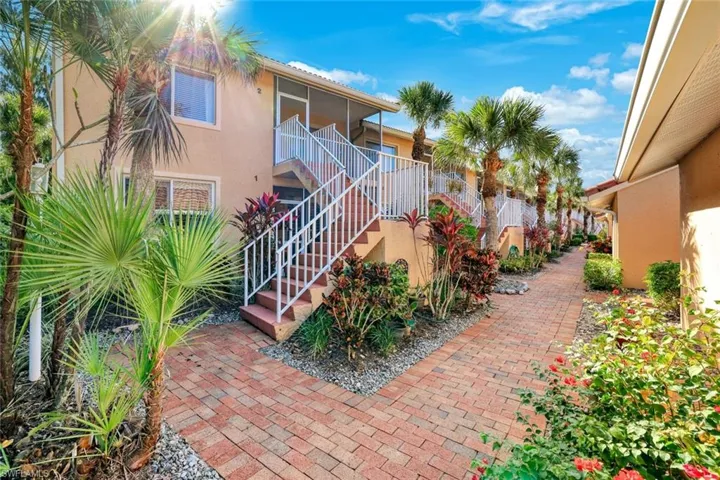 Multiple levels of residential units, each with a private screened balcony