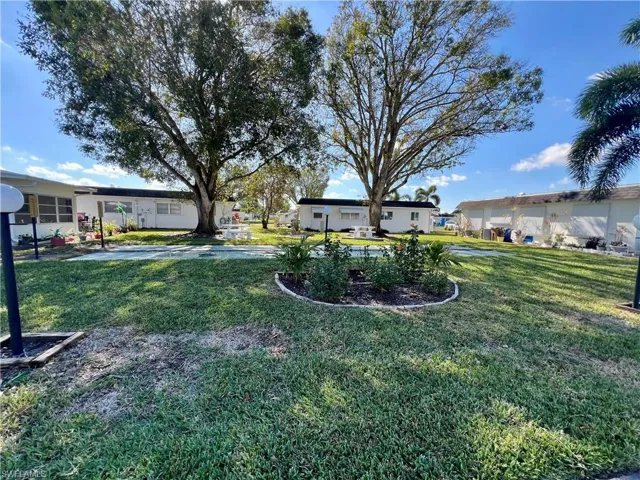 Common area featuring barbecue/picnic area and shuffleboard.