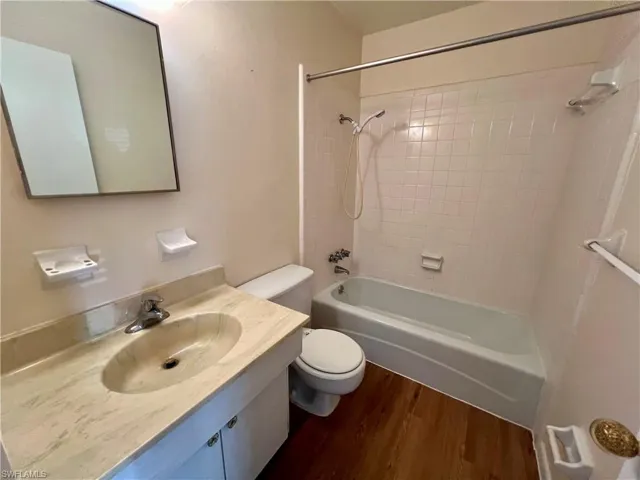 Full bathroom with , vanity, toilet, and tiled shower / bath