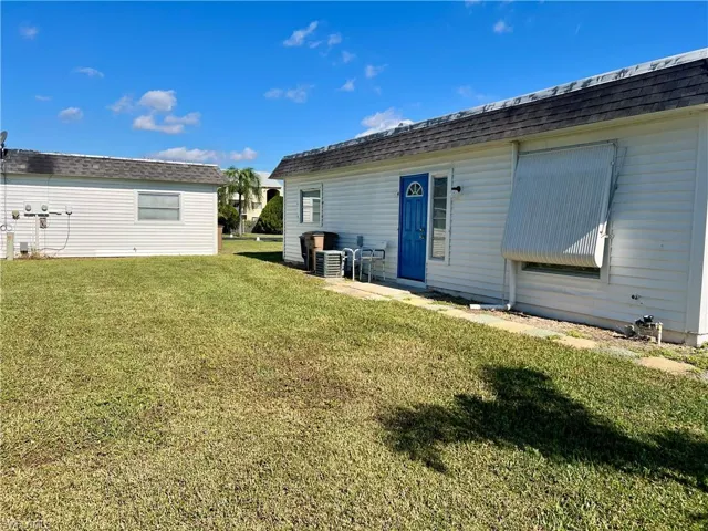 Rear view of house with a yard