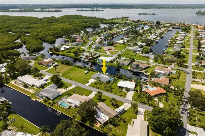 Birds eye view of property with a water view