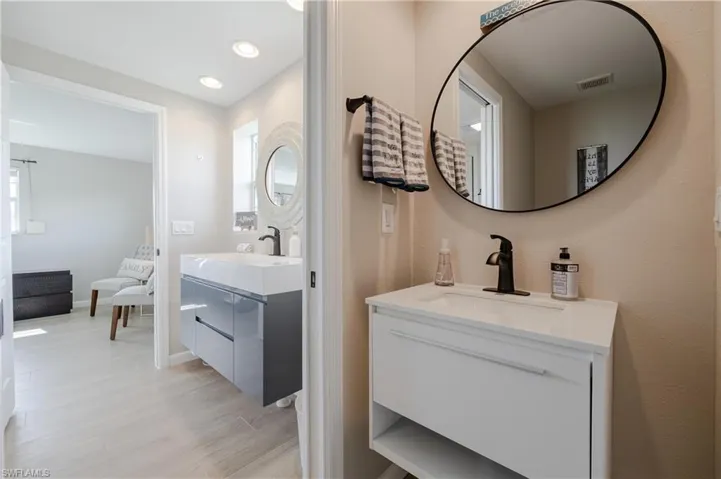 Bathroom featuring a wealth of natural light, double vanity, and hardwood / wood-style floors