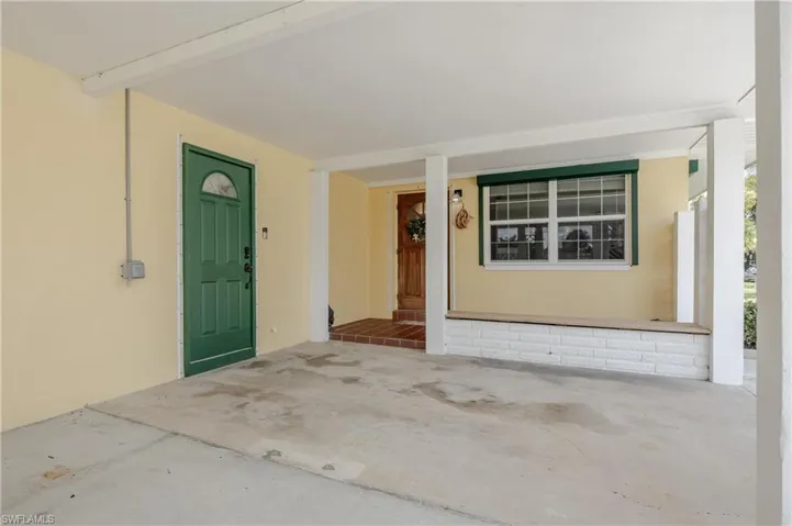 Doorway to property with covered porch