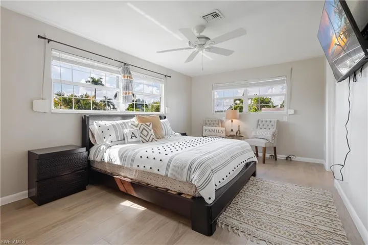 Bedroom with ceiling fan and light hardwood / wood-style floors