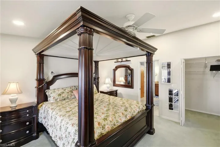 Bedroom with light carpet, recessed lighting, ceiling fan, and a closet