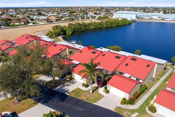 Aerial view of residential area featuring a nearby body of water