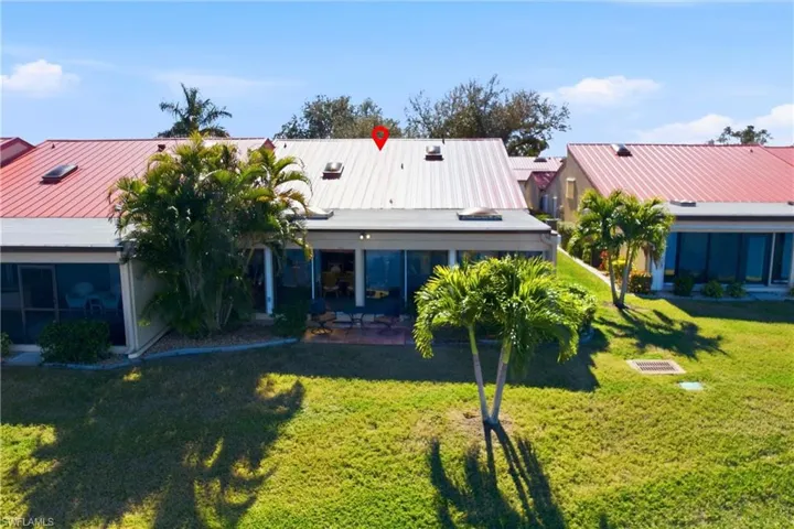 Rear view of house with a patio, a metal roof, and a standing seam roof