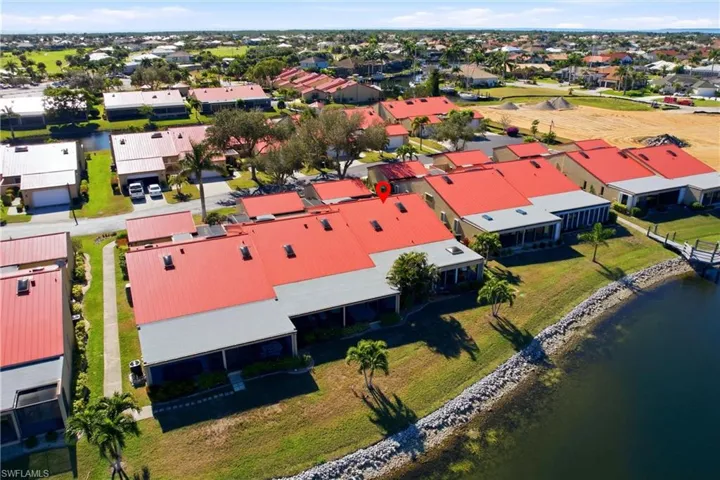 Aerial view of residential area featuring a large body of water
