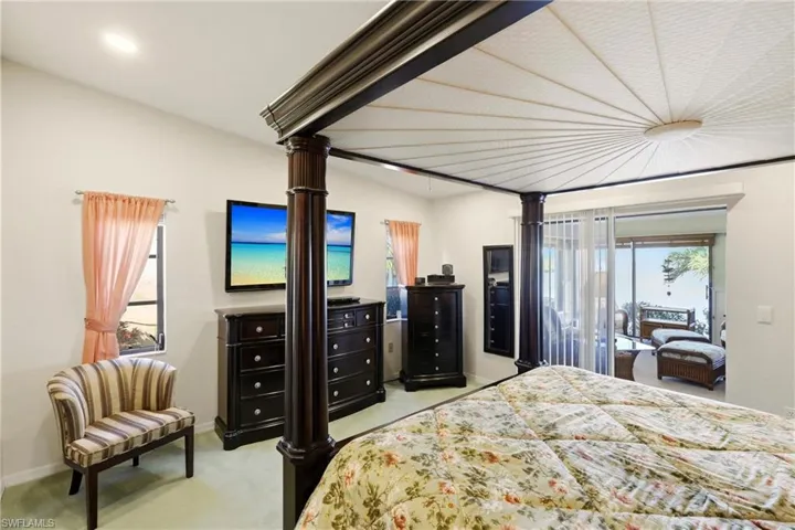 Bedroom featuring light carpet and baseboards