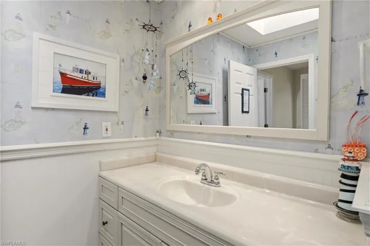 Bathroom with vanity and a skylight