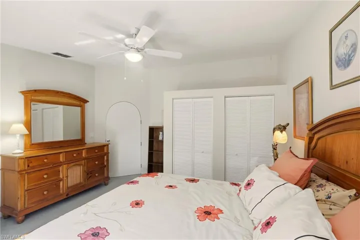 Bedroom featuring multiple closets and ceiling fan