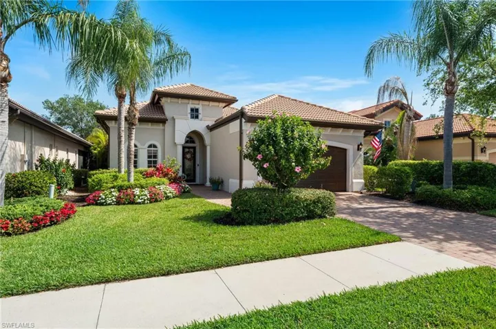 Mediterranean / spanish-style home with stucco siding, a tile roof, an attached garage, and decorative driveway