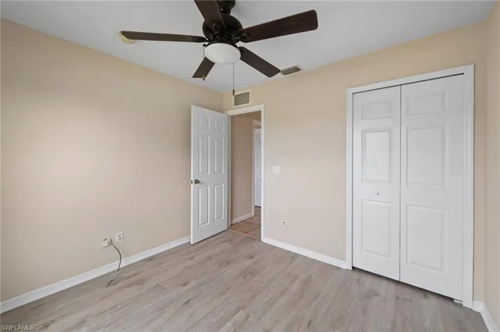 Unfurnished bedroom with light hardwood / wood-style floors, a closet, and ceiling fan